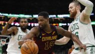 Cleveland Cavaliers center Tristan Thompson (13) works the ball against Boston Celtics guard Kyrie Irving (11) and center Aron Baynes (46) in the second quarter at TD Garden. Credit: David Butler II-USA Today Sports 