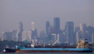 Oil tankers pass the skyline of Singapore June 8, 2016. Reuters/Edgar Su. 