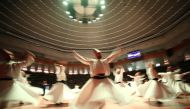 Members of Konya Turkish Sufi Music Ensemble perform Sema ceremony during an event to commemorate 745th death anniversary of Mevlana Jalaluddin al-Rumi, in Konya, Turkey on December 16, 2018 (Abdullah Co?kun/Anadolu Agency)