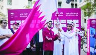 The officials of Msheireb Properties wave Qatari flag as part of the National Day celebrations at Msheireb Downtown Doha. 