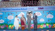 Commodore Irfan Taj, Defence Attache of Pakistan Embassy, receives a memento from Riyaz Bakali   during the Qatar National Day Educational Fiesta 2018 at TNG. 