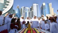 Dr Eng Saad bin Ahmed Al Muhannadi, President of the Public Works Authority (Ashghal), along with other officials cutting a cake to celebrate Qatar National Day. 