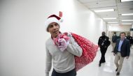 This photograph, obtained courtesy of the Obama Foundation, shows former US President Barack Obama delivering gifts, greeting patients and their parents at Children’s National Medical Center in Washington, DC, December 19, 2018. AFP PHOTO / Courtesy of th