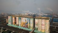 A mural listed by the Guinness World Records as the largest in the world is displayed on a grain silo in Incheon port, west of Seoul on December 19, 2018.  AFP / Ed Jones 