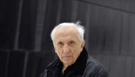 (FILES) In this file photo taken on May 28, 2014, French painter, engraver and sculptor, Pierre Soulages poses in front of one of his paintings at the museum of the « Outrenoir » master (« ultra-black »), in the French southwestern city of Rodez. AFP / Pa