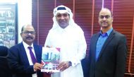 Jumbo Electronics’ Sajed Jassim Mohammed Sulaiman, Vice-Chairman & Managing Director, hands over the 2019 Business Strategy Document to C V Rappai, Director & CEO, as Rohit Pandit, COO, looks on.