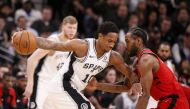  San Antonio Spurs shooting guard DeMar DeRozan (10) dribbles the ball as Toronto Raptors small forward Kawhi Leonard (right) defends during the second half at AT&T Center.  Soobum Im