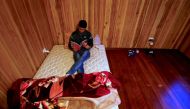 REPRESENTATIVE IMAGE: Ali Rasooli, a refugee from Afghanistan, sits on his mattress reading a book in a house he rents with other refugees in the western Sydney suburb of Guildford, Australia, July 17, 2016. Reuters/David Gray