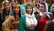 FILE PHOTO: Syrian-Kurdish women model traditional Kurdish attire during a fashion show in the northeastern Syrian city of Qamishli on March 10, 2017 which coincides with the Day of Kurdish Clothing. AFP/Delil Souleiman