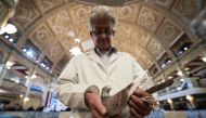 Show steward John Watson inspects his recently purchased pigeon at the annual two-day 'British Homing World Show of the Year' held in the Winter Gardens in Blackpool, north west England on January 20, 2019.  AFP / Oli Scarff 