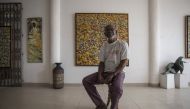 Ablade Glover, Ghanaian artist and educator, poses for a portrait in his showroom inside the Artist Alliance Gallery in Accra on December 11, 2018. AFP / CRISTINA ALDEHUELA 