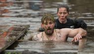 A competitor negotiates a water obstacle in the Tough Guy endurance event near Wolverhampton, central England, on January 27, 2019.  AFP / Oli Scarff 