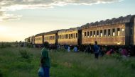 Commuters wait to board a train heading for the city on January 29, 2019, in Cowdray Park township, in Bulawayo, Zimbabwe. AFP / Zinyange Auntony