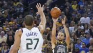 Golden State Warriors guard Stephen Curry (30) shoots the basketball against Utah Jazz center Rudy Gobert (27) during the second quarter at Oracle Arena. Kyle Terada 
