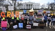 People protest against US President Donald Trump’s national emergency declaration in front of the White House on February 18, 2019 in Washington, DC.  AFP / Brendan Smialowski
 