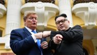 S President Donald Trump impersonator Russel White (L) and North Korean leader Kim Jong Un impersonator Howard X (R) pose together for photographs outside the Opera House in Hanoi on February 22, 2019. / AFP / Manan VATSYAYANA