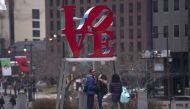 A young couple has their photo taken in front of Robert Indiana's iconic LOVE sculpture in Philadelphia, February 12, 2015. Reuters/Charles Mostoller  