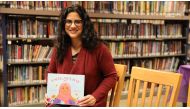 Hena Khan poses for a photo with her new children's book 