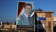 A picture of President Bashar al-Assad is seen in Ramouseh, a government controlled area of Aleppo,  Syria, December 8, 2016. Reuters/Omar Sanadiki