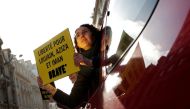 Demonstrators from Amnesty International hold placards outside the Saudi Arabian Embassy on International Women's day to urge Saudi authorities to release jailed women's rights activists Loujain al-Hathloul, Eman al-Nafjan and Aziza al-Yousef in Paris, Fr