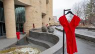 Dresses hang on the grounds of the National Museum of the American Indian in Washington, D.C. on March 1, 2019, as part of the REDress Project, an art installation by artist Jaime Black. Handout photo by National Museum of the American Indian staff. 