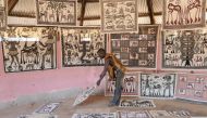 An artist displays his paintings in his workshop, in the village of Fakaha, a remote village in northern Ivory Coast, some 650 kilometres (400 miles) from Abidjan on January 24, 2019. AFP / Sia Kambou