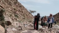 Umm Yasser (C), an Egyptian Bedouin woman guide from the Hamada tribe, leads a group of hikers in Wadi el-Sahu in South Sinai governorate on March 29, 2019, during the first 