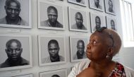 Pulane Koboekae looks at a picture of her older brother Richard Motsoahae during a tour of the gallows at Kgosi Mampuru Correctional Facility in Pretoria, South Africa on August 15, 2018. AFP / Phill Magakoe 

