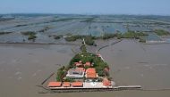 This aerial photo taken on March 9, 2019 shows a view of a Buddhist temple isolated by coastal erosion in Samut Chin village, off the shore of Samut Prakan. AFP / Jonathan Klein