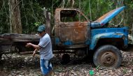 Arara indigenous chielf Motjibi, 43, stands next to a burnt truck as he patrols the Arara indigenous land, in Para state, Brazil on March 13, 2019.  AFP / Mauro Pimentel 