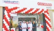 The officials cutting a ribbon at the opening of Ooredoo Express shop.