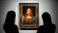  In this file photo taken on October 24, 2017 Christie's employees pose in front of a painting entitled Salvator Mundi by Italian polymath Leonardo da Vinci at a photocall at Christie's auction house in central London ahead of its sale at Christie's New Y