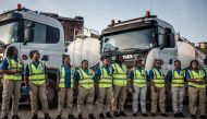 Female truck drivers stand at the Ladybird Logistics meeting point before the start of the workday in Takoradi, western Ghana, on April 3, 2019.  AFP / Cristina Aldehuela 