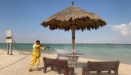 A worker busy cleaning a beach premise. 