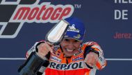 Repsol Honda Team's Marc Marquez celebrates on the podium with a trophy after winning the race REUTERS/Jon Nazca