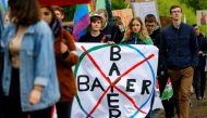 Environmental activists protesting against the merger of Germany's pharmaceutical and chemical maker Bayer AG with U.S. seeds and agrochemicals company Monsanto, march through Germany's former capital Bonn before Bayer's annual general shareholders meetin