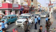 Yemeni policemen (in blue) and Huthi fighters control the traffic at the centre of the port city of Hodeidah, around 230 kilometres west of the capital Sanaa, on May 13, 2019. (AFP)