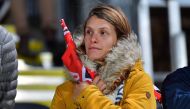 A woman stands in honour of Anzac Day during the Super Rugby match between the Canterbury Crusaders of New Zealand and the Sunwolves of Japan in Christchurch on April 21, 2018. AFP/Marty Melville