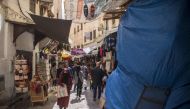 Tourists and locals walk in the 9th-century walled medina in the ancient Moroccan city of Fez on April 11, 2019. AFP / FADEL SENNA