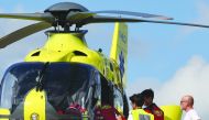 Doctors and a nurse are seen on the roof of the Centre Hospitalier of Roanne, from where Team Ineos rider Great Britain's Christopher Froome is to be transferred by helicopter to another hospital, after he fell on a training run ahead of the fourth stage 