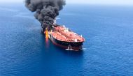 Fire and smoke billowing from a tanker said to have been attacked in the waters of the Gulf of Oman.   AFP / ISNA / -
