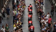 Germany's Team Sunweb cycling team rides through the Saint-Hubert Royal Galleries on their way to the team presentation ceremony in Brussels on July 4, 2019, two days prior to the start of the 106th edition of the Tour de France cycling race.  AFP / Anne-