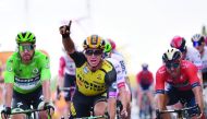 Netherlands' Dylan Groenewegen (C) celebrates, past Slovakia's Peter Sagan (L), wearing the best sprinter's green jersey, as he wins on the finish line of the seventh stage of the 106th edition of the Tour de France cycling race between Belfort and Chalon