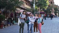 This photo taken on June 3, 2019 shows Malaysian tourists in the restored old city area of Kashgar, in China's western Xinjiang region. AFP / Greg Baker