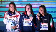 Gold medallist USA's Lilly King (C), silver medallist Russia's Yuliya Efimova (L) and bronze medallist Italy's Martina Carraro (R) pose during the medals ceremony after the final of the women's 100m breaststroke event during the swimming competition at th