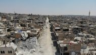 An aerial view taken on August 3, 2019, shows destroyed buildings in the town of Khan Sheikhun in the southern countryside of Idlib.   AFP / Omar HAJ KADOUR