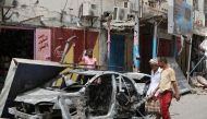 People check cars that were burned during clashes in Aden, Yemen August 12, 2019. REUTERS/Fawaz Salman