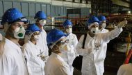 People take part in a guided tour at the inoperative Ignalina nuclear power plant in Visaginas, Lithuania, on July 31, 2019.  AFP / Petras Malukas