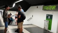 Two police officers in plainclothes check the identification documents of two presumed pickpockets (L) at a metro station in Barcelona on August 14, 2019.  AFP / Lluis Gene
 


. Pictures by Lluis Gene
