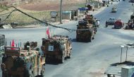 A picture taken on August 29, 2019 shows Turkish military vehicles passing through the town of Saraqib in the northwestern Idlib province. AFP / Omar Haj Kadour
